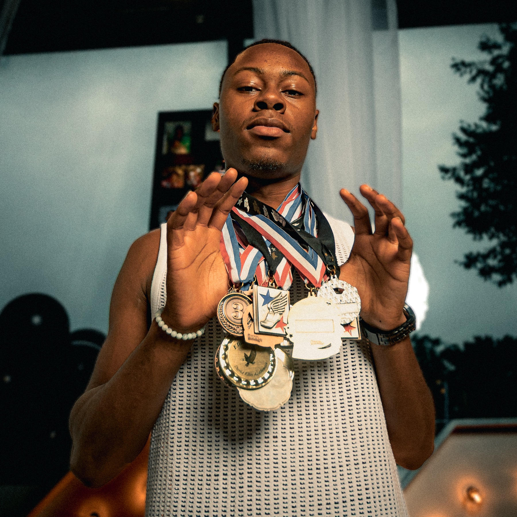 Detroit lifestyle portrait featuring a client proudly wearing athletic medals
